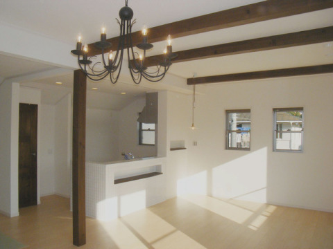 カウンターにタイルが貼ってある対面キッチン。化粧梁と照明が優雅な雰囲気のスペース。